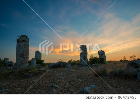 Beautyful sunrise over The Stone Desert Pobiti Kamani - fabulous rock phenomenon in Varna Province, Bulgaria - tourist destination Beautyful sunrise over The Stone Desert Pobiti Kamani - fabulous rock phenomenon in Varna Province, Bulgaria - tourist destination 86472455