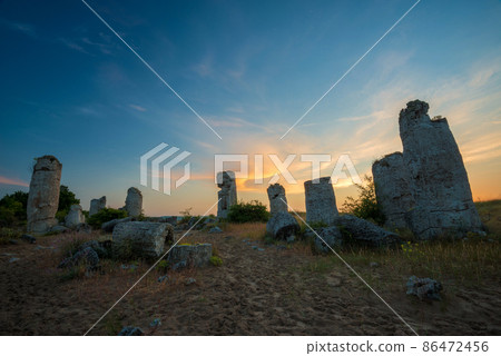 Beautyful sunrise over The Stone Desert Pobiti Kamani - fabulous rock phenomenon in Varna Province, Bulgaria - tourist destination 86472456