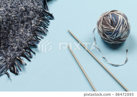 Woolen yarn for knitting. Ball of natural wool yarn and knitting needles 86472893