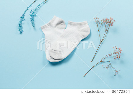 Pair of women socks on blue background. 86472894