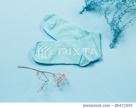 Pair of women socks on blue background. Pair of women socks on blue background. 86472895