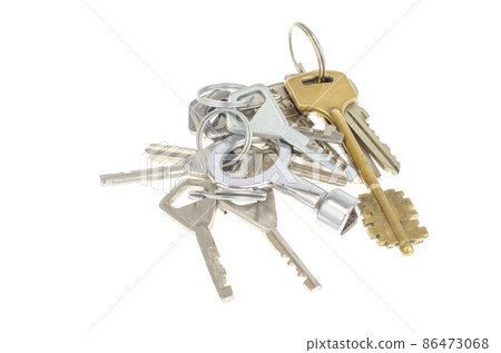 Bundles of old keys on white background. Bundles of old keys on white background. 86473068