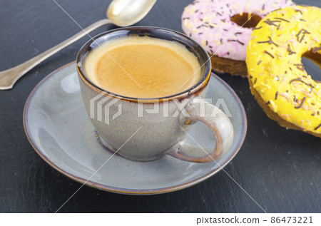 Cup of espresso with fresh pastries for breakfast on black stone background. Cup of espresso with fresh pastries for breakfast on black stone background. 86473221