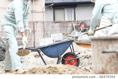 Men in work clothes working at the construction site Men in work clothes working at the construction site 86474504