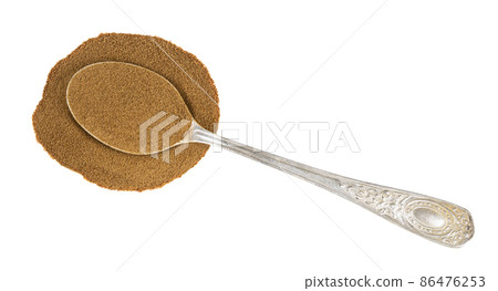 top view of spoon with ground chicory in pile 86476253