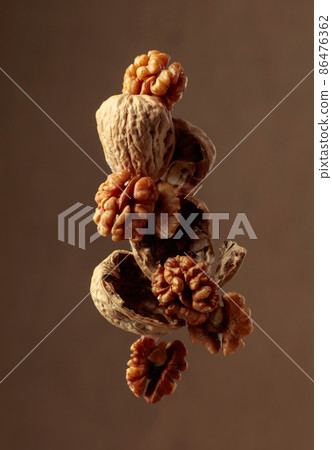 Walnuts on a brown background. 86476362