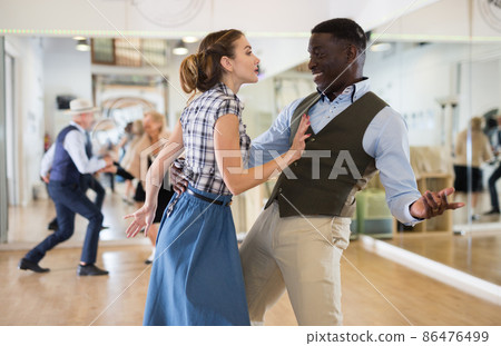 Pair dancing lindy hop during rehearsal Pair dancing lindy hop during rehearsal 86476499