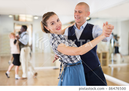 Happy man and woman enjoying ballroom dancing Happy man and woman enjoying ballroom dancing 86476500
