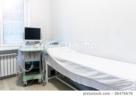 Doctor's office with couch and diagnosis tools. Close-up of ultrasound machine in clinic. Modern hospital with high technology equipment. Health care, diagnostic and disease prevention concept Doctor's office with couch and diagnosis tools. Close-up of ultrasound machine in clinic. Modern hospital with high technology equipment. Health care, diagnostic and disease prevention concept 86476676