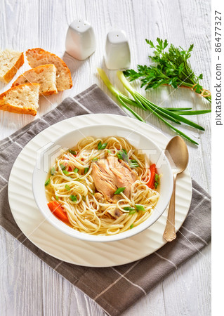 chicken noodle soup with carrots and scallion chicken noodle soup with carrots and scallion 86477327