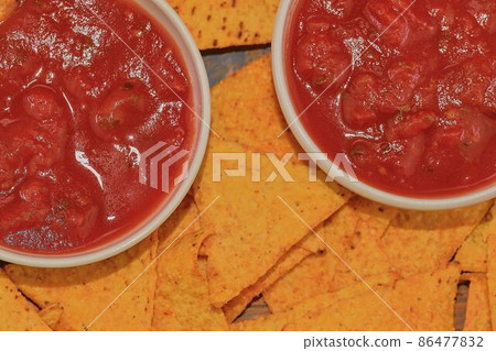 Chili corn-chips with salsa dip on wooden background Chili corn-chips with salsa dip on wooden background 86477832