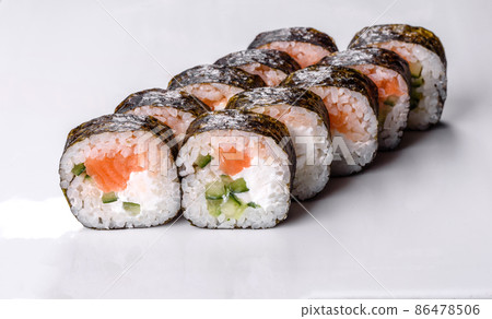 Traditional delicious fresh sushi roll set on a white background Traditional delicious fresh sushi roll set on a white background 86478506