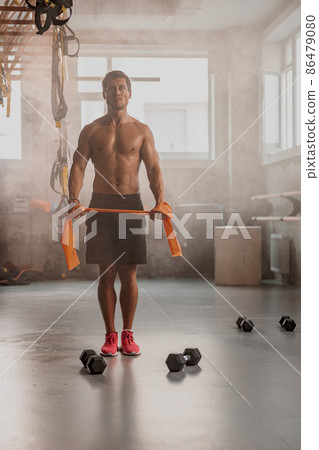 Handsome male personal trainer working in gym Handsome male personal trainer working in gym 86479080