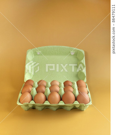 Packaging of chicken eggs on a yellow background in isolation 86479111