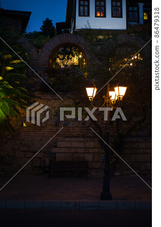 Beautiful ancient lamp at night, close-up. Bulgaria, Nessebar Beautiful ancient lamp at night, close-up. Bulgaria, Nessebar 86479318