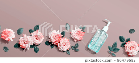 Sanitizer bottle with pink roses overhead view Sanitizer bottle with pink roses overhead view 86479682