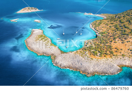 Aerial view of beautiful sea bay, yachts and boats at sunset in summer. Aerial view of beautiful sea bay, yachts and boats at sunset in summer. 86479760