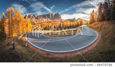 Winding road in mountains and orange trees at colorful sunset in autumn in Italy. Landscape 86479786