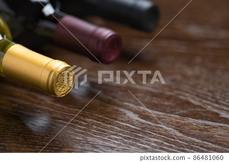 Various Wine Bottles on a Reflective Wood Surface Abstract. 86481060
