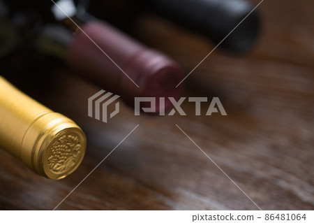 Various Wine Bottles on a Reflective Wood Surface Abstract. Various Wine Bottles on a Reflective Wood Surface Abstract. 86481064