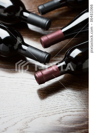 Various Wine Bottles on a Reflective Wood Surface Abstract. 86481066