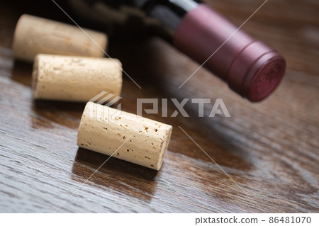 Wine Bottle and Corks on a Reflective Wood Surface Abstract. 86481070