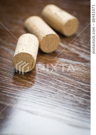 Blank Wine Corks Resting on Reflective wood Surface. Blank Wine Corks Resting on Reflective wood Surface. 86481071