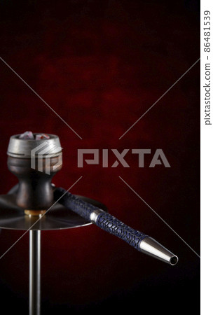 Modern hookah, on a beautiful dark background. Vertical location. Copy space. Smoking shisha. Modern hookah, on a beautiful dark background. Vertical location. Copy space. Smoking shisha. 86481539