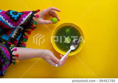 Woman eating traditional Egyptian Molokhia soup  86481780