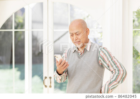 Senior men using smartphones Senior men using smartphones 86482045