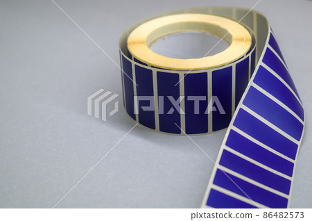 Roller tape blue self-adhesive label. Material for printing and marking products. Thermal label. Selective focus, copy space 86482573
