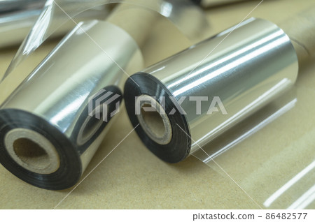 Thermal transfer ribbon - TTR. Wax thermo ribbon on cardboard reel for barcode. Supply material for printing industry. Selective focus 86482577