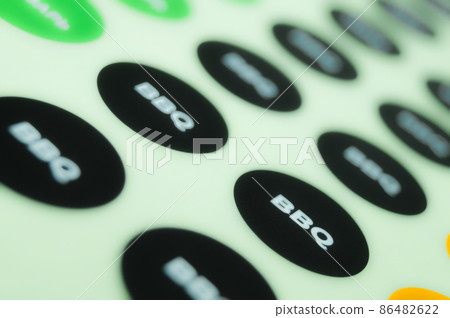 BBQ sticker, a self-adhesive label on a paper substrate. Print labels on a roll machine in a printing house. Selective focus BBQ sticker, a self-adhesive label on a paper substrate. Print labels on a roll machine in a printing house. Selective focus 86482622