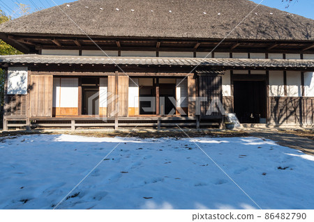Thatched roof and snow scene 86482790
