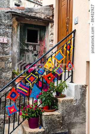 Rural houses and narrow streets in the medieval village Geraci Siculo, Italy 86482927