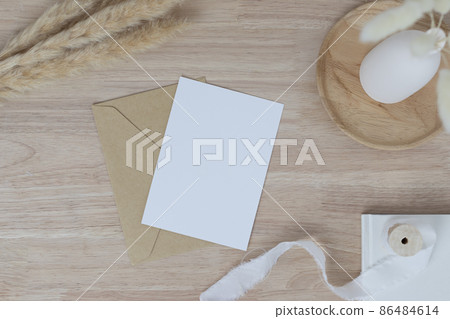 Blank paper cards, Blank greeting card invitation Mockup with Dried Bunny Tail grass in vase on a wood table, wood desk background, Minimal wood table workplace composition, flat lay, mockup Blank paper cards, Blank greeting card invitation Mockup with Dried Bunny Tail grass in vase on a wood table, wood desk background, Minimal wood table workplace composition, flat lay, mockup 86484614