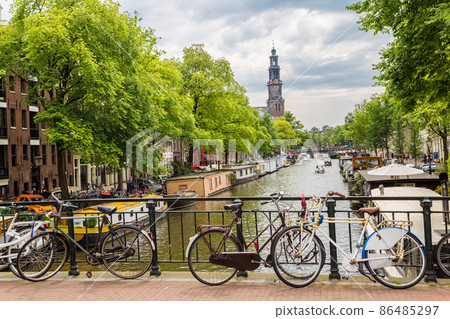 Bicycles on a bridge over the canals of Amsterdam Bicycles on a bridge over the canals of Amsterdam 86485297
