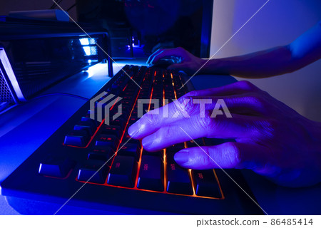Playing computer game with gaming keyboard, shot with macro probe lens 86485414