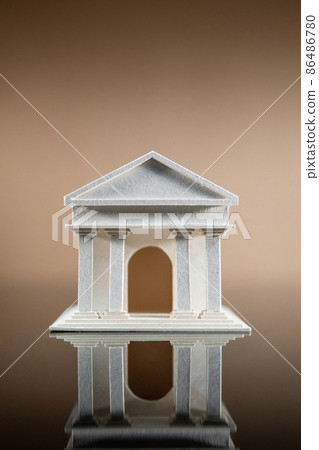 Banking concept. Paper bank building model reflected on table. 86486780