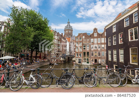 Bicycles on a bridge over the canals of Amsterdam 86487520