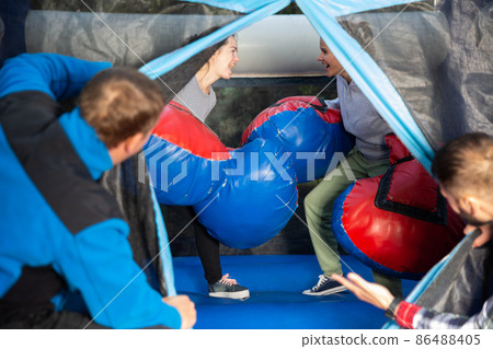 Women boxing on inflatable ring 86488405