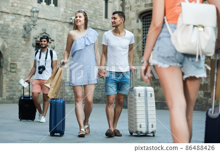 Friendly couple in shorts with luggage 86488426