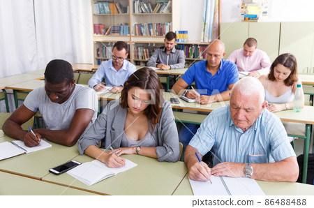 Students mixed age take a written exam Students mixed age take a written exam 86488488