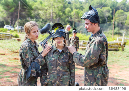 Paintball team calming upset girl after losing match Paintball team calming upset girl after losing match 86488496