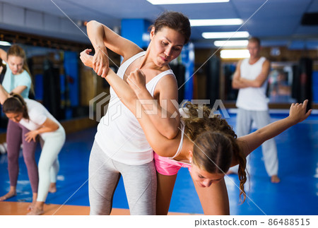 Woman performing armlock movement 86488515