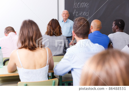Mature teacher standing in front of students 86488531
