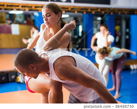 Young woman training knee strike 86488730