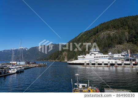 West Vancouver, BC, Canada - April 13 2021 : BC Ferries Horseshoe Bay Ferry Terminal. Cherry blossoms full bloom in springtime. 86490830