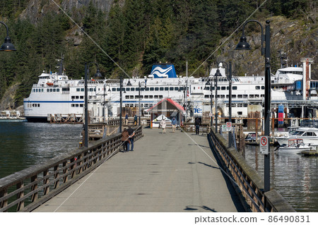 West Vancouver, BC, Canada - April 13 2021 : BC Ferries Horseshoe Bay Ferry Terminal. Cherry blossoms full bloom in springtime. West Vancouver, BC, Canada - April 13 2021 : BC Ferries Horseshoe Bay Ferry Terminal. Cherry blossoms full bloom in springtime. 86490831