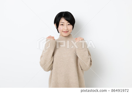 Woman doing guts pose with both hands Woman doing guts pose with both hands 86491972